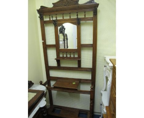 AN EDWARDIAN OAK HAT, COAT AND STICK STAND with bevelled glass mirror 205cm (h) x 89cm (w) x 29cm (d)