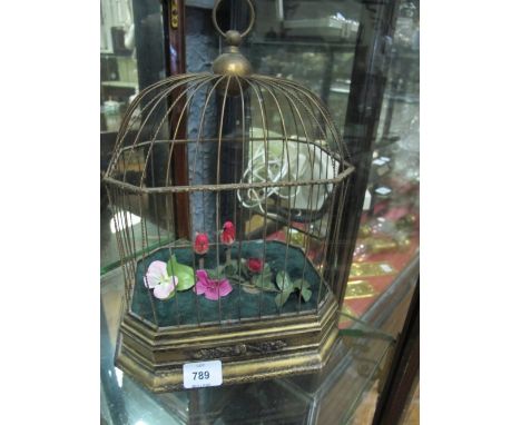 A CONTINENTAL GILTWOOD AND BRASS AUTOMATON BIRD GROUP IN CAGE