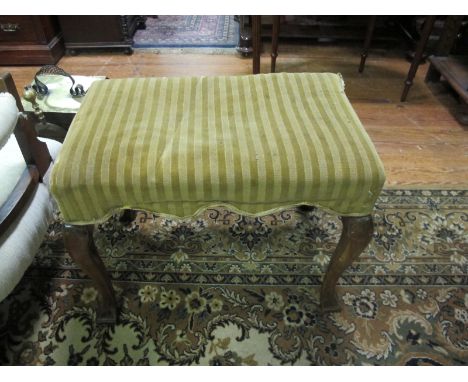 A MAHOGANY STOOL the rectangular upholstered seat on cabriole legs with block feet