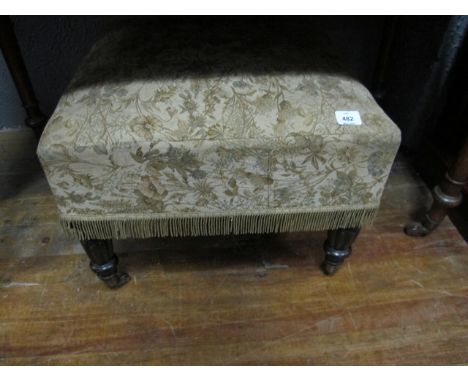 A REGENCY MAHOGANY STOOL the upholstered seat raised on lobed and ring turned legs with brass caps and casters 44cm (h) x 56c