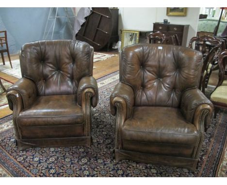 A FINE PAIR OF HIDE UPHOLSTERED LIBRARY CHAIRS each with a deep button upholstered back with scroll arms and loose cushion on