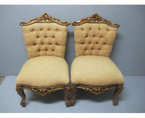 A PAIR OF CONTINENTAL UPHOLSTERED SIDE CHAIRS each with a pierced top rail above a button upholstered back and seat on cabrio