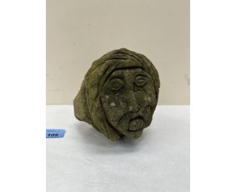An architectural carved stone mask of ecclesiastic origin. 6' high