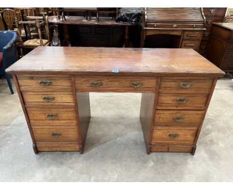 A late Victorian walnut kneehole desk, with nine channel moulded drawers. 54' wide