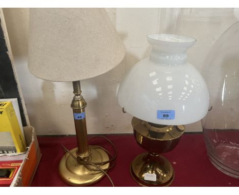 A brass oillamp and a brass table lamp