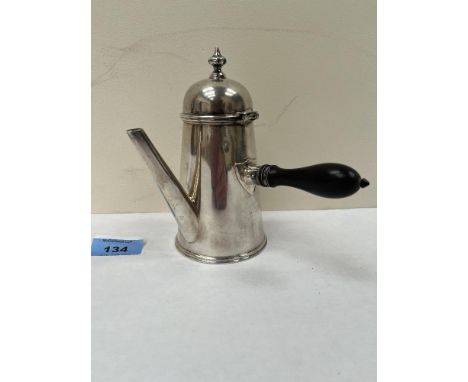 A Victorian silver chocolate pot of tapered conical form, the domed lid with finial. Engraved monogram. London 1878. 6' high.