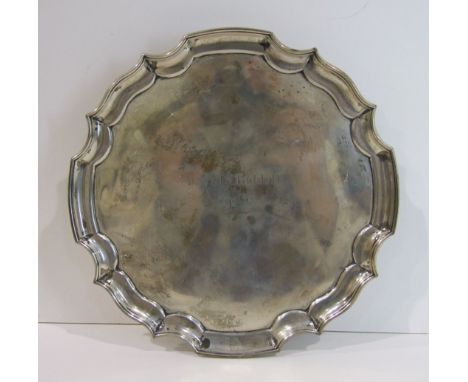 A silver card tray with Chippendale border on three scroll feet, Sheffield 1951, 20.5cm diameter___11oz.