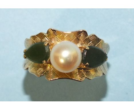 A gold dress ring set a cultured pearl and two jade "leaves" on textured mount, indistinctly marked, size P, 4.8g.