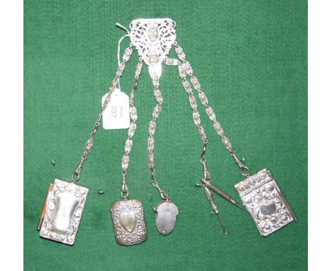 A silver plated chatelaine with five mask-link chains supporting two notebooks, Vesta, button hook, propelling pencil and pin