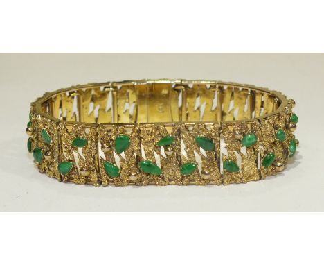 A 14k yellow gold bracelet of textured and pierced linked plaques, each set with two jade cabochons, 17.5cm long, 37.4g.
