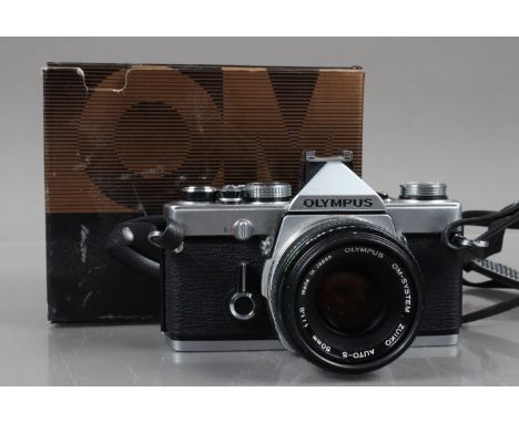 An Olympus OM-1n SLR Camera, shutter working, meter responsive, self timer working, body G, with Zuiko 50mm f/1.8 lens, barre