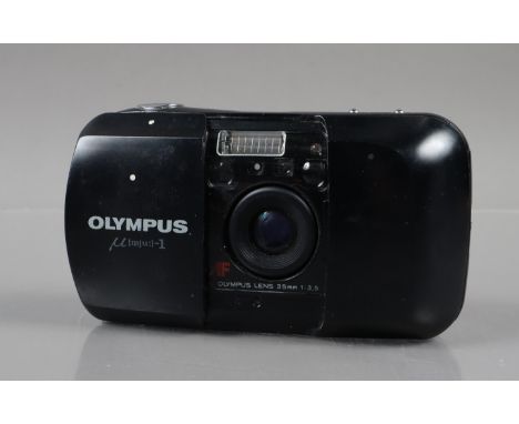 An Olympus mju 1 Compact Camera, powers up, shutter working, flash working, self timer working, body G, some surface scratche