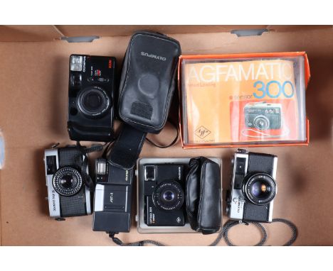 A Group of Compact Cameras, an Olympus Trip 35, shutter working, light cell responsive, aperture responsive in auto setting, 