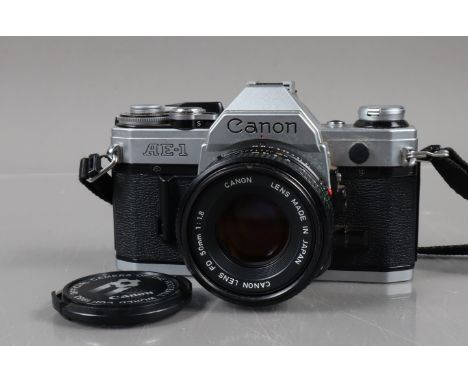 A Canon AE-1 SLR Camera, chrome, shutter working, meter responsive, self timer working, body G, with FD 50mm f/1.8 lens, barr