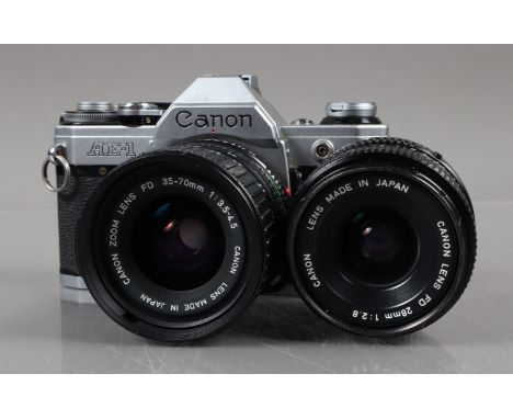 A Canon AE-1 SLR Camera, chrome, shutter working, meter responsive, self timer working, body G, with 28mm f/2.8 &amp; 35-70mm