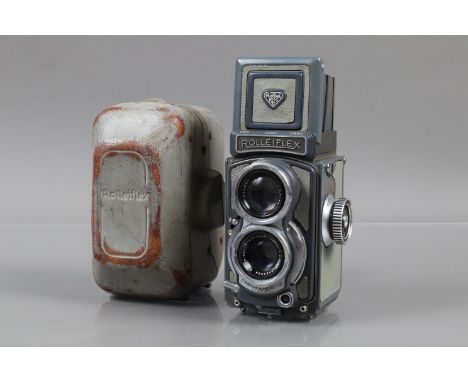 A Rolleiflex Baby Grey TLR Camera,  shutter working, body F-G, elements F, haze/fungus, in worn Rollei case 