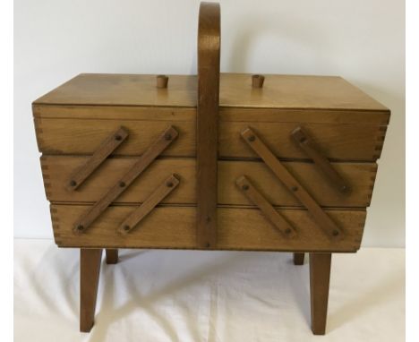 A Vintage wooden concertina workbox on legs.  