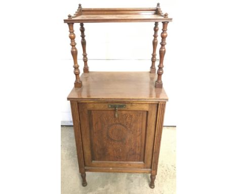 An antique oak coal box with carved decoration and shelf above.  