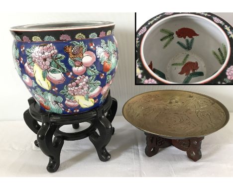 A oriental ceramic planter with interior fish decoration with wooden stand. Together with a oriental dragon design brass dish