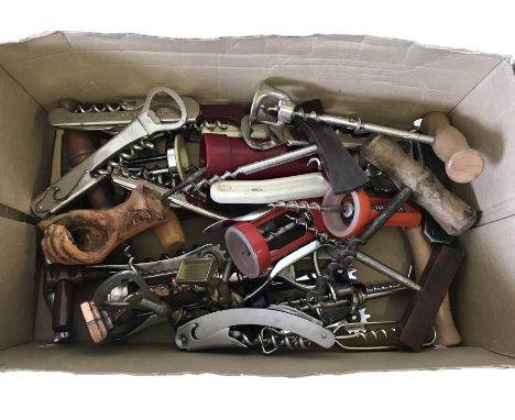 A box of assorted vintage corkscrews and bottle openers.  