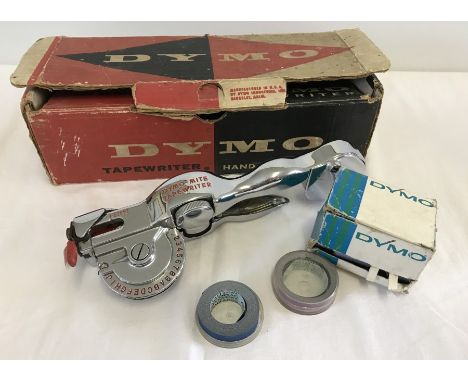 A vintage Dymo-Mite Tapewriter in original box. Includes several rolls of tape. 