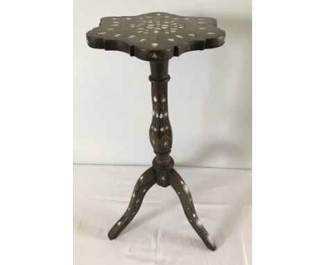 A  oriental wooden tripod table. with inlaid mother of pearl decoration. pprox 58cm tall.