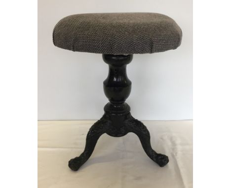 A vintage screw top adjustable piano stool with cast iron tripod feet. Has been re-upholstered. 