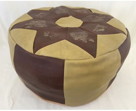 A c1970's leather pouffe. In buff & brown colour with gilt printed Arab lady and desert scene decoration to top. 