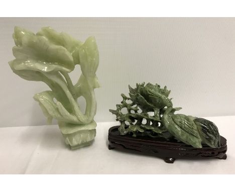 2 pieces of vintage carved Jade. One on wooden stand. Light green piece 17cm tall. Dark green piece 15cm long.