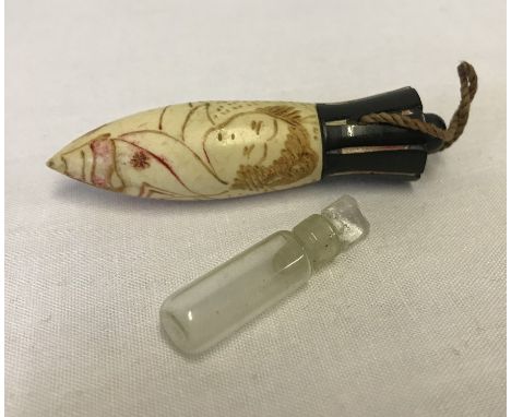 A vintage decorated bone perfume flask with glass inner bottle. Oriental style decoration. Measures approx 7cm long.