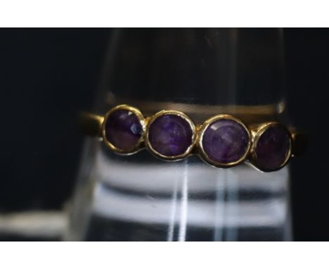 A four-stone amethyst ring set in yellow metal. 1.9 g approximately.(B.P. 24% incl. VAT) CONDITION REPORT: Thumbnail chip to 