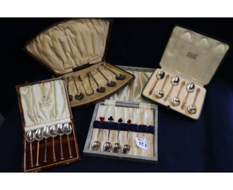 Cased set of six silver coffee spoons, cased set of six silver apostle spoons, four silver and enamel diamonds, spades, clubs