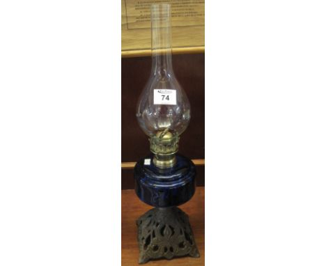 Brass single burner oil lamp with glass reservoir and pierced, cast metal base, having clear glass shade.(B.P. 24% incl. VAT)