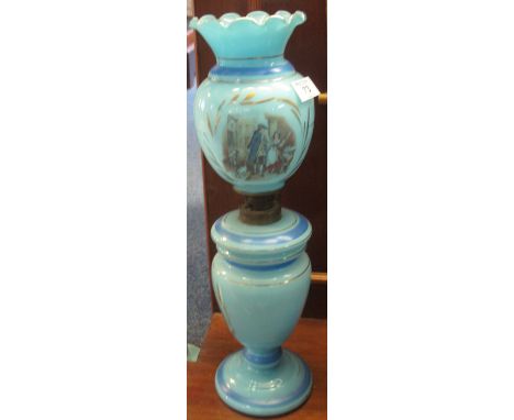 Blue opaline glass oil lamp with printed matching shade on vase-shaped base.(B.P. 24% incl. VAT)