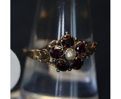 Victorian garnet and pearl ring. 1.5g approximately.(B.P. 24% incl. VAT) CONDITION REPORT: Approx. 9mm diameterThe mount is i