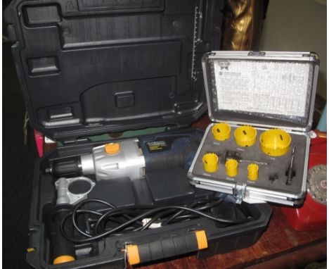 Macallister 1050 watt hammer drill in plastic case, together with cased set of large hole drilling bits. (B.P. 24% incl. VAT)