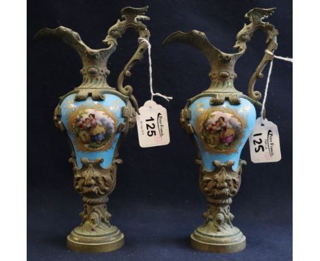 Pair of 19th century continental, yellow metal mounted, pocelain ewers, the bodies with reserved, handpainted portrait panels