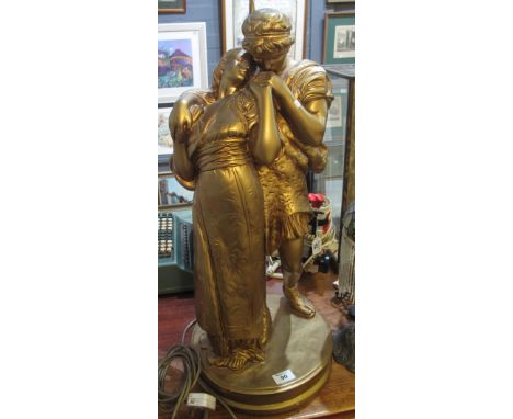 Large gilded composition figural table lamp with shade.(B.P. 24% incl. VAT) 