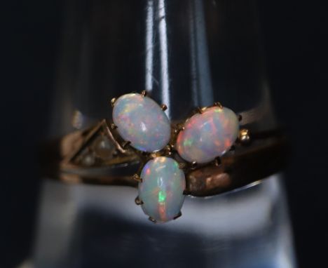 An opal and seed pearl ring in rose-coloured metal. 1.5g approximately.(B.P. 24% incl. VAT)