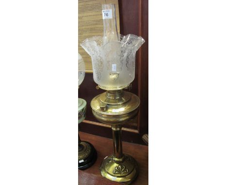 Brass double burner oil lamp with brass reservoir on Art Nouveau style brass pedestal base, etched frosted glass shade and cl