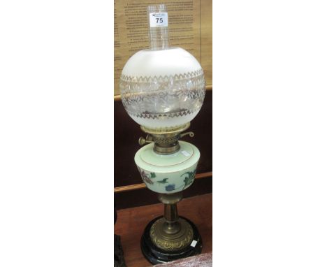 Brass double burner oil lamp with painted glass reservoir on brass pedestal with ceramic base, frosted glass shade and clear 