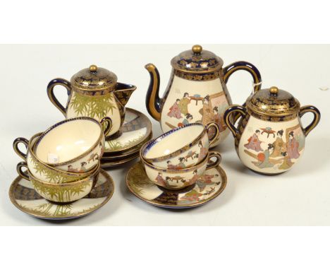 A Japanese Satsuma tea service, comprising a teapot, sugar bowl, milk jug and five cups and saucers, all with character seal 