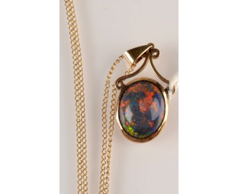 A 9ct gold mounted opal pendant and chain. 