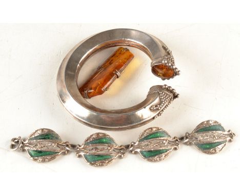 An African bangle with amber terminals, a green enamel bracelet and one other piece. 
