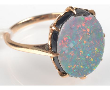 An opal doublet 15ct. gold ring 