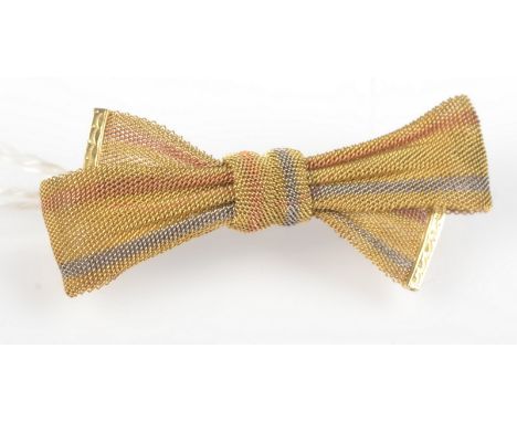 A 15ct. three colour gold gauze, bow brooch, 4.7g.  Length 4cm. Width 2cm.
Condition report: In original good condition, 15ct