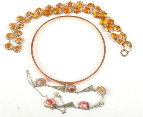 An engine turned 9ct. gold, metal core bangle, together with two paste necklaces.