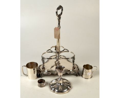 An early Victorian, Sheffield plated triple bottle stand, a candlestick, two christening mugs and a silver napkin ring. 