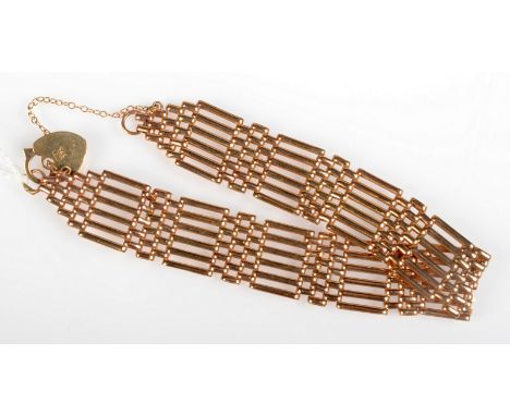 A 9ct. gold gate link bracelet with padlock clasp, 11.8g. 