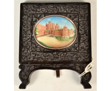 An Indian architectural miniature, The Red Fort, in carved ebony easel frame, 7 x 5cm.